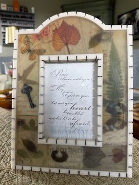 Botanical tabletop frame containing a Bible verse from John 14:27.